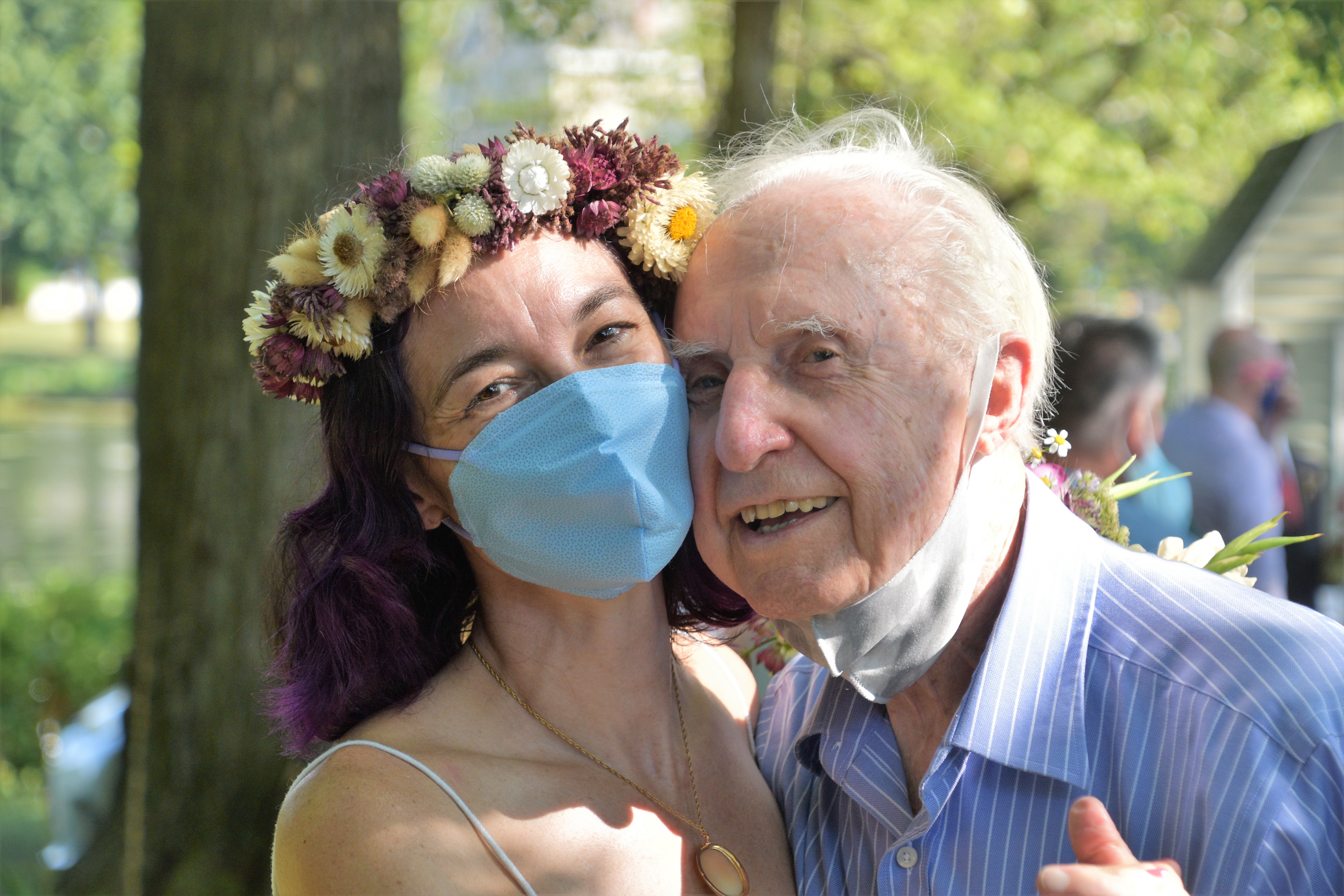 bride wearing pandemic mask with elderly relative