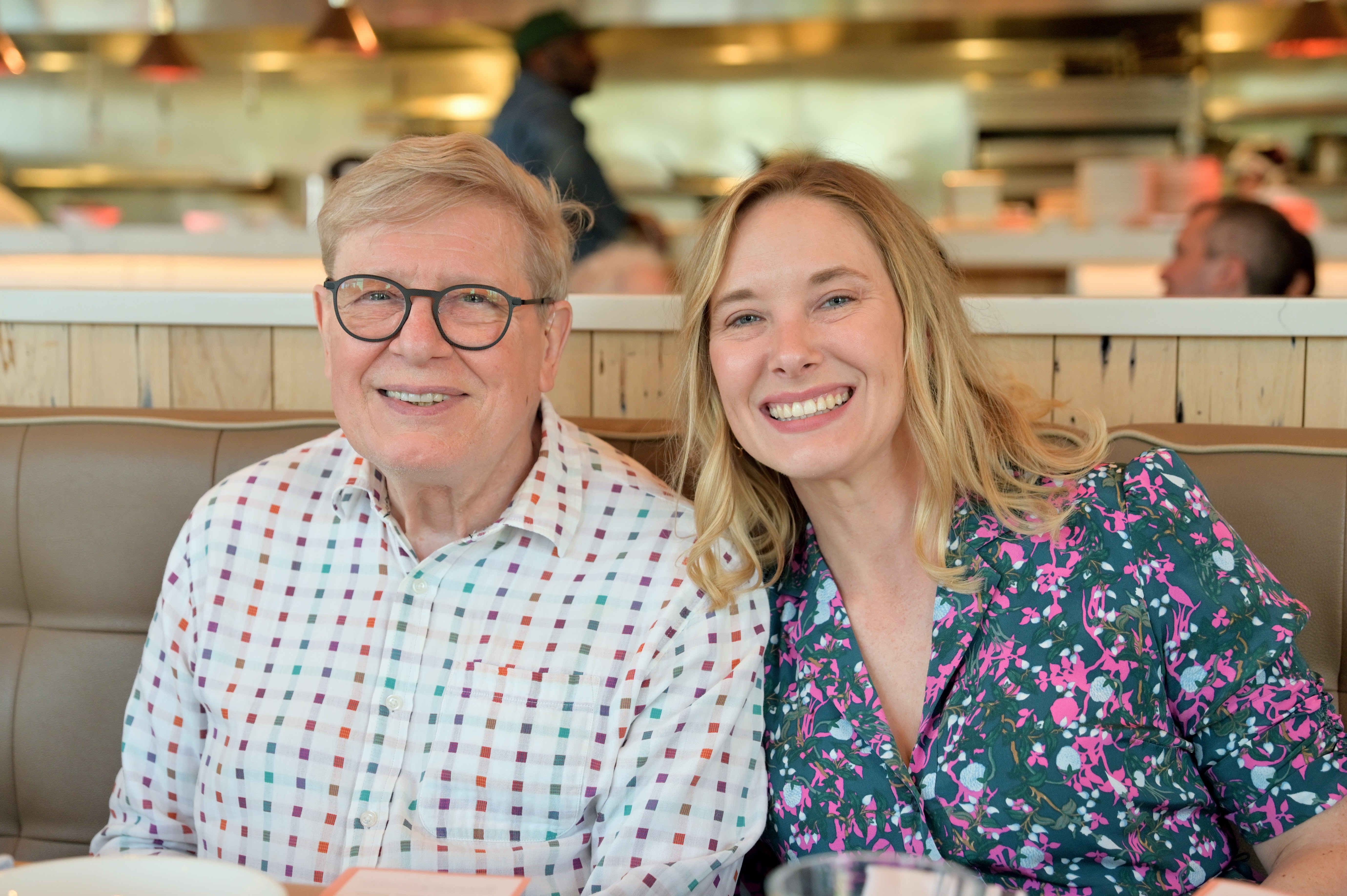 man sitting next to grown daughter