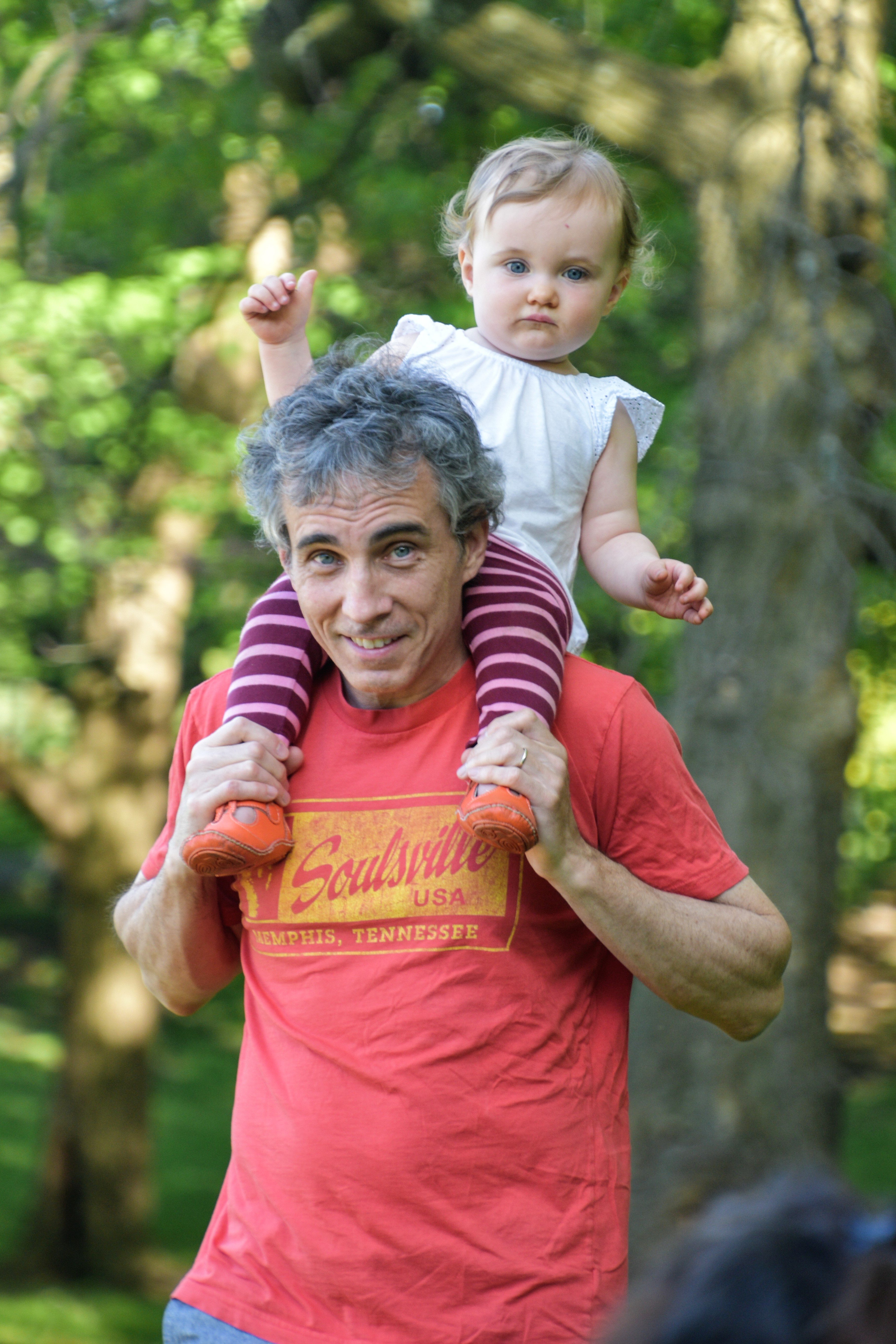 dad with infant daughter on shoulder
