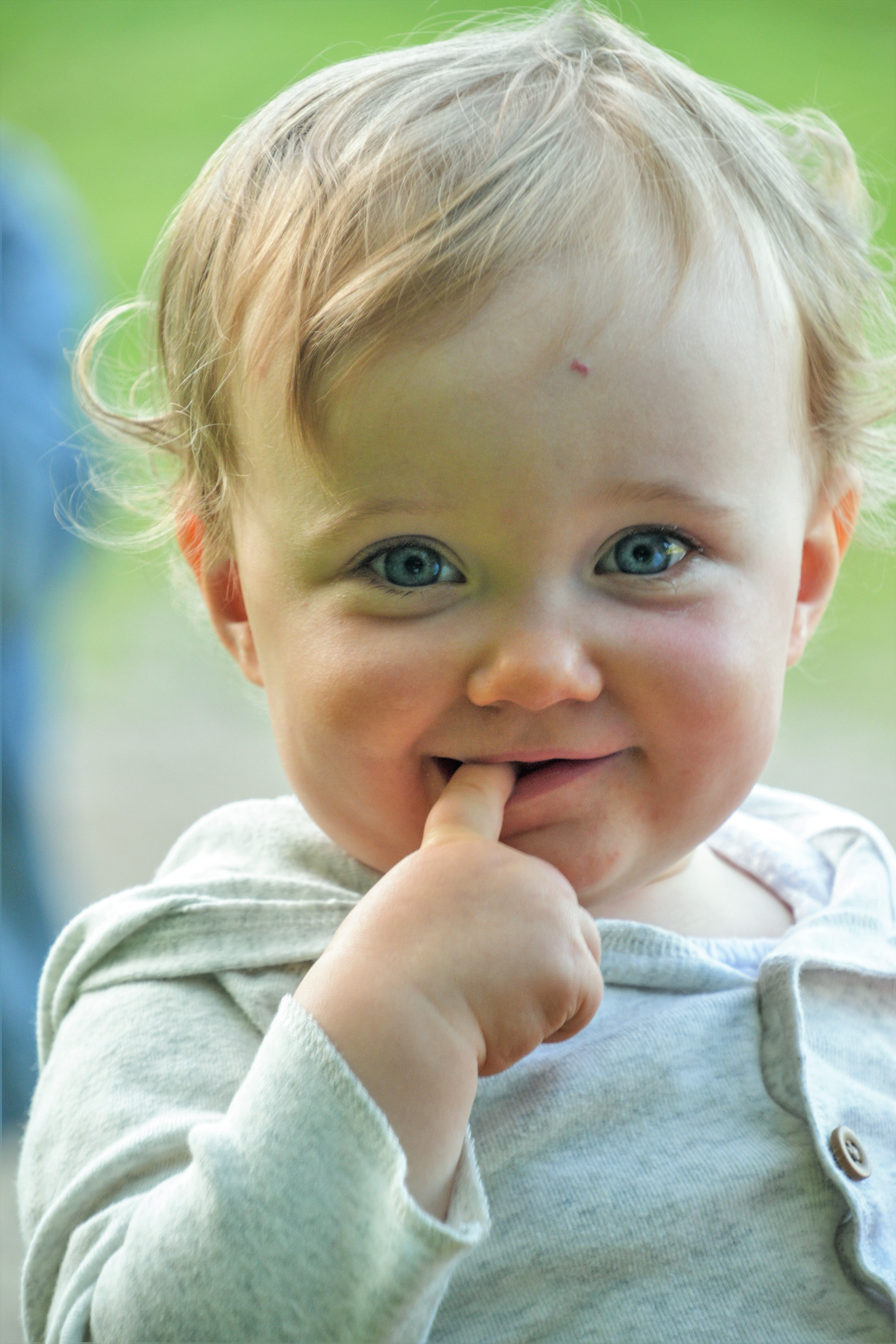 infant with finger in her mouth